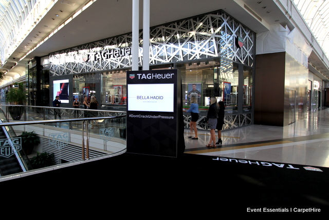 Two media walls, black carpet and decal branding